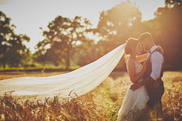 couple in the cornfield at summer wedding in Devon