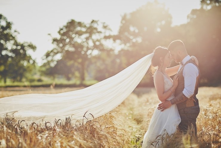 wedding photography of golden hour sunset bride and groom portraits in a cron field in Devon