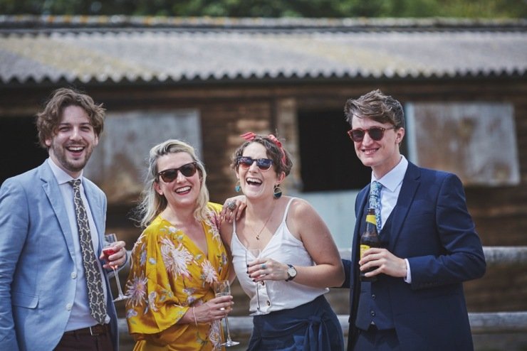 relaxed wedding photography of guests having fun at Upton Barn and walled garden Devon