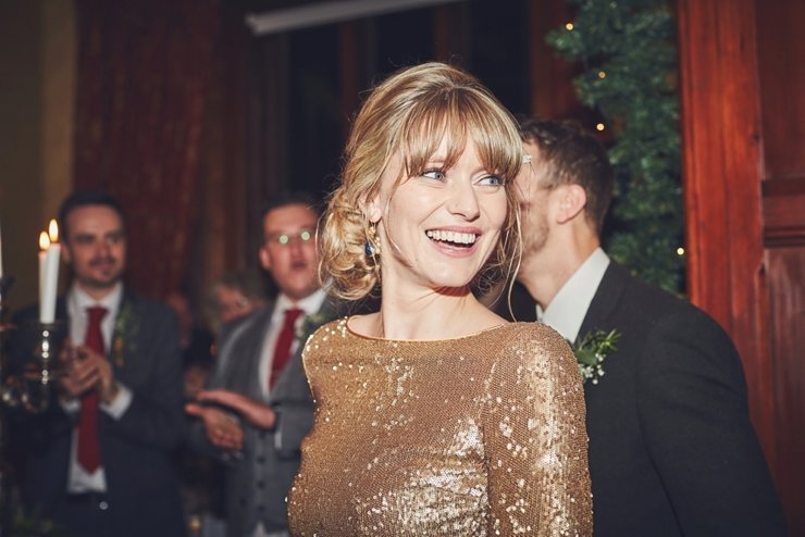 entrance of a happy bride to wedding breakfast at winter wedding at huntsham court