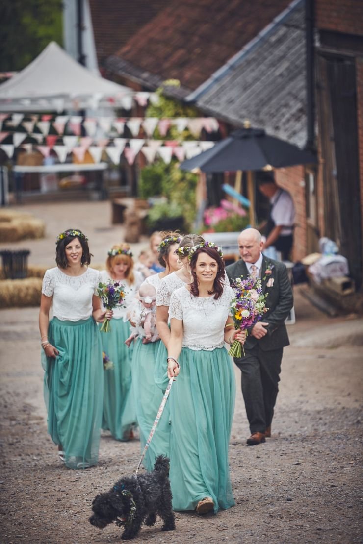 bride and bridesmaids walking to ceremony at West Town Farm in Devon