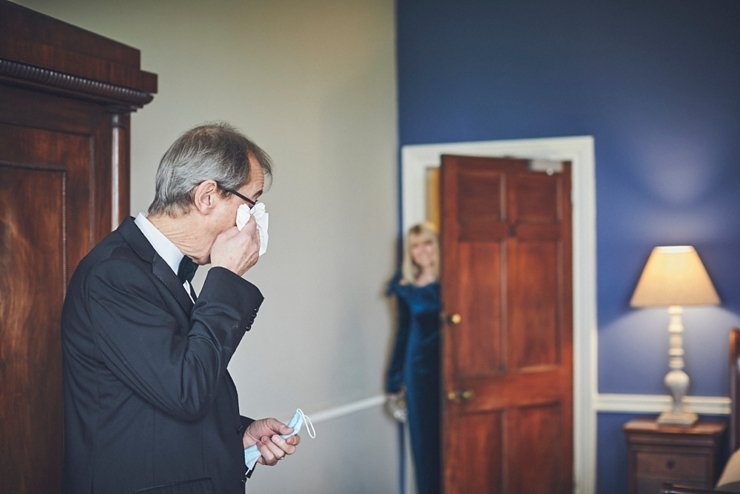 Dad wiping his eyes emotional before the ceremony at a micro wedding at rockbeare manor devon