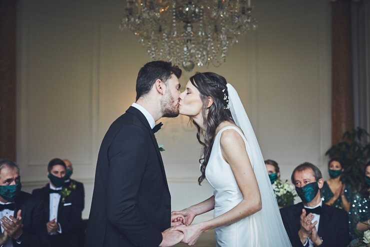 bride and groom first kiss at small wedding at Rockbeare manor in Devon