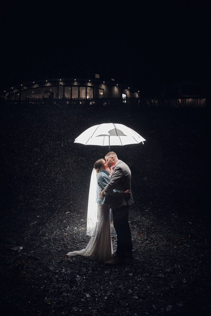 rainy back lit off camera flash shot with umbrella at tunnels beaches wedding Devon