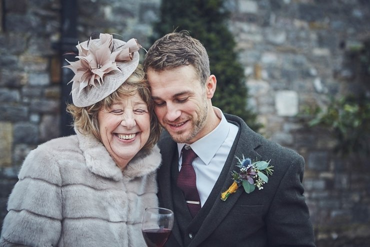 beautiful candid moment of groom cuddling Mum after winter wedding ceremony at Coco wedding venue in Devon