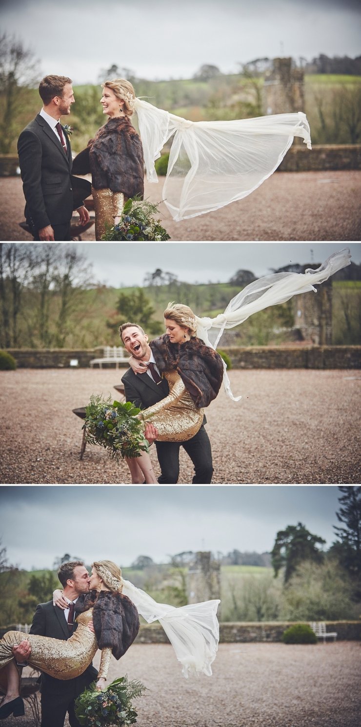 bride's veil blowing at relaxed winter wedding at Huntsham Court Devon groom picks her up laughing