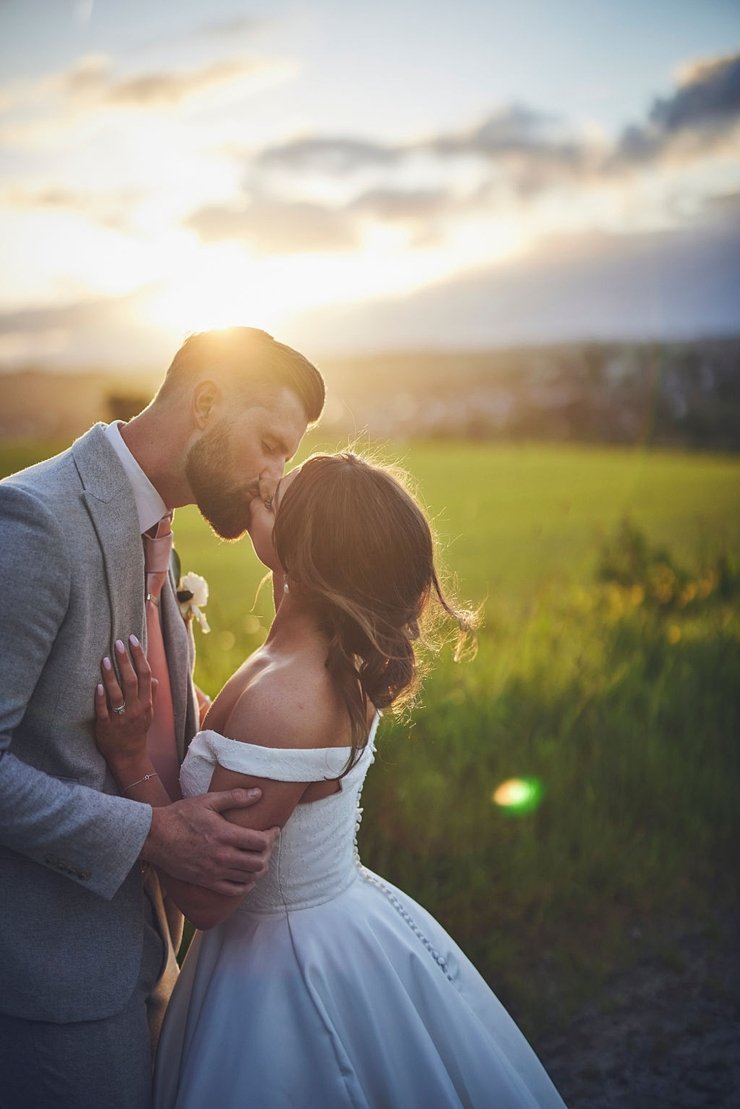 bride and groom kissing in the golden hour at Upton Barn and walled garden
