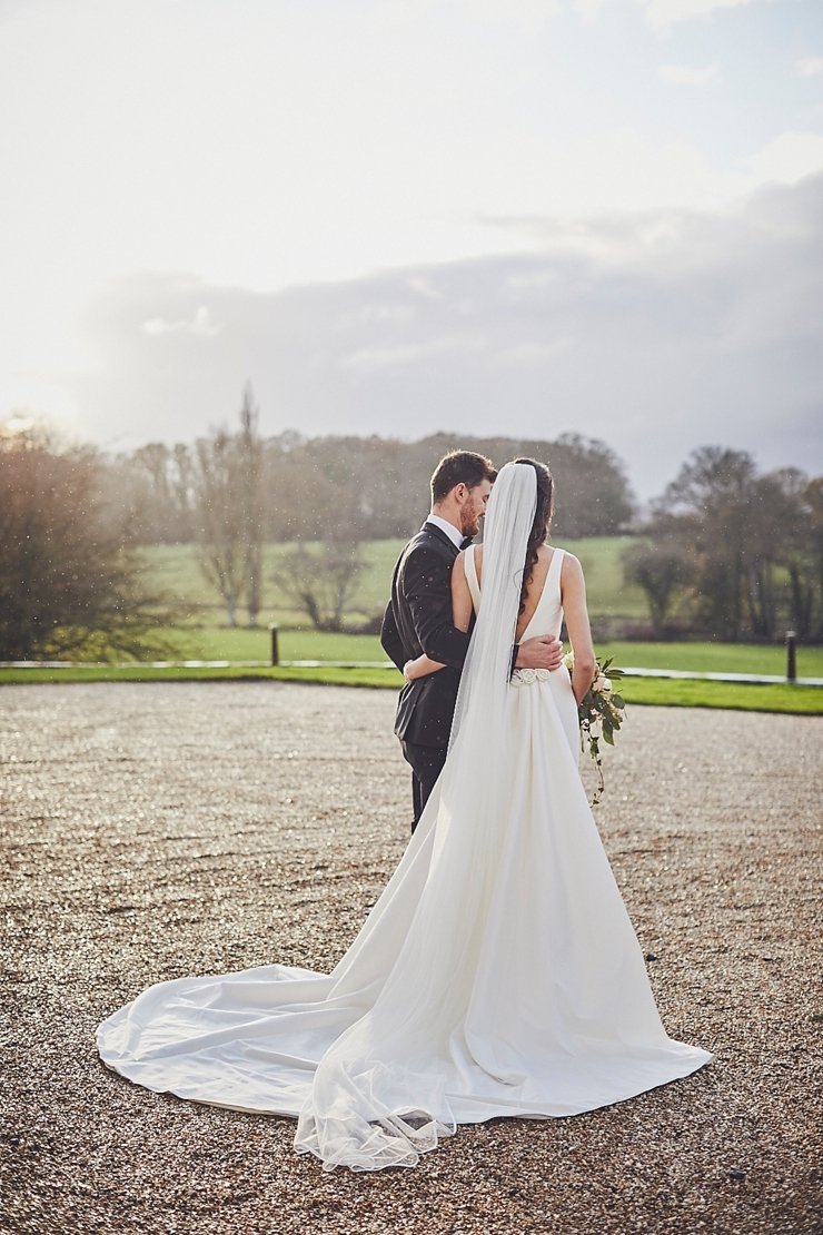 bride and groom walking in the rain at mini winter wedding at Rockbeare Manor in Devon