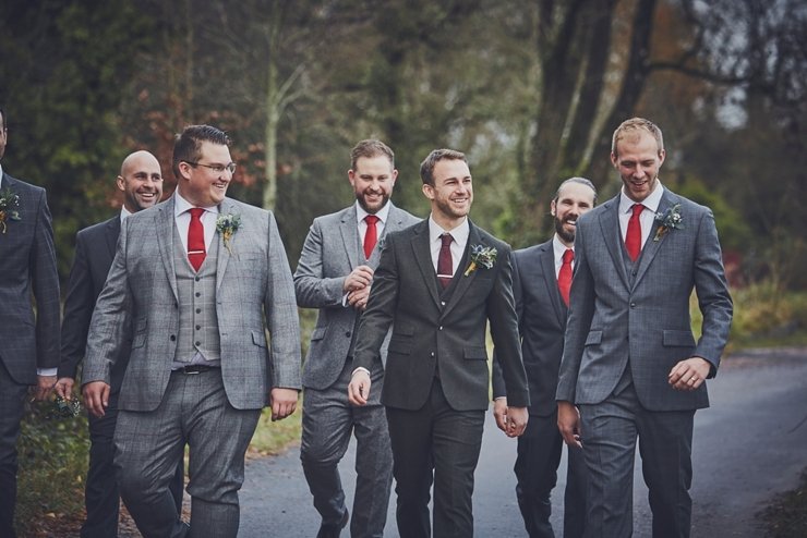 groom and best men and ushers walk to the wedding ceremony at Huntsham Court Devon