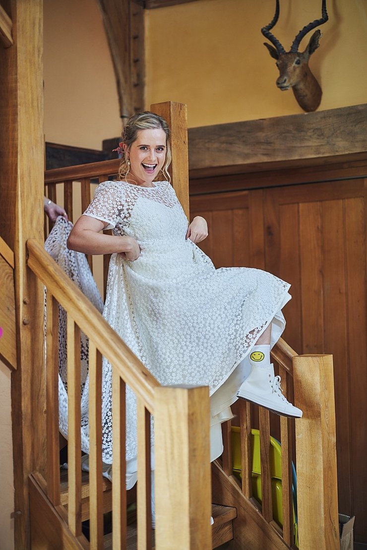 bride wearing smiley socks and white converse for boho weddign at Hayne
