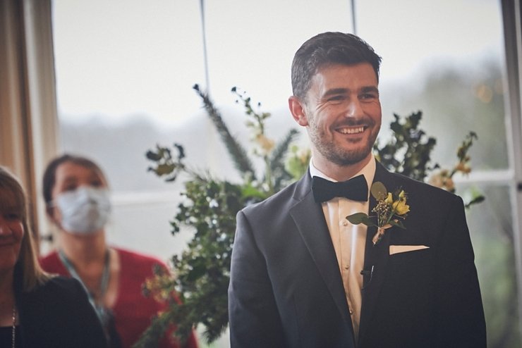 wedding photography of groom smiling at bride to be at small Rockbeare manor devon wedding