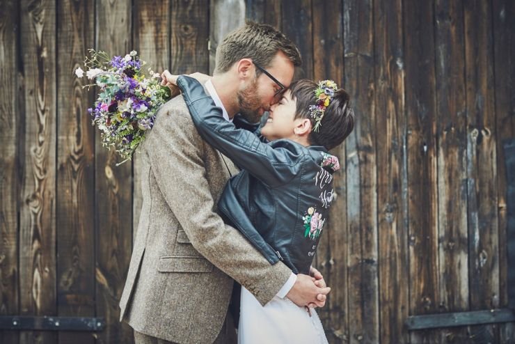 bride wearing an illustrated leather jacket and groom at a West Town Farm wedding in devon