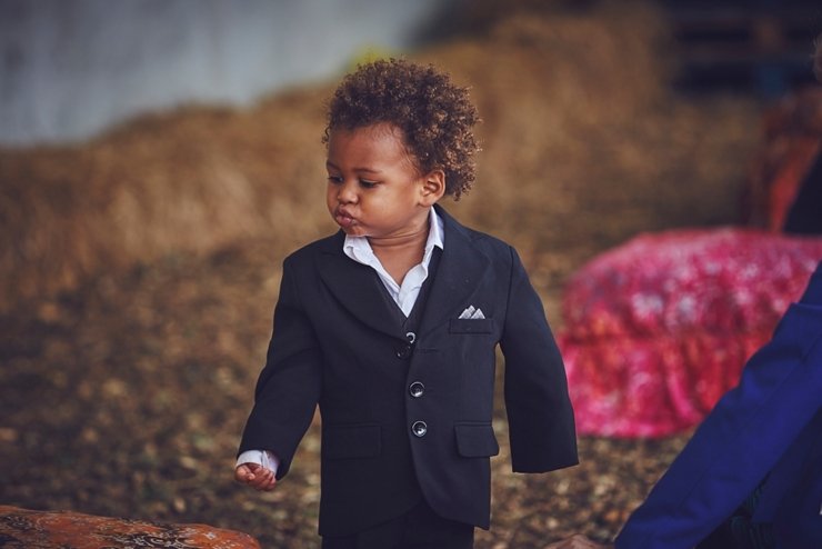 little boy dressed in suit at sustainable wedding in Devon