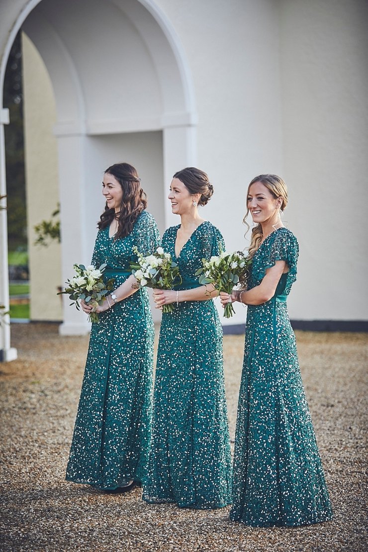 bridesmaids in green sequinned long dresses at small winter wedding at Rockbeare manor in Devon