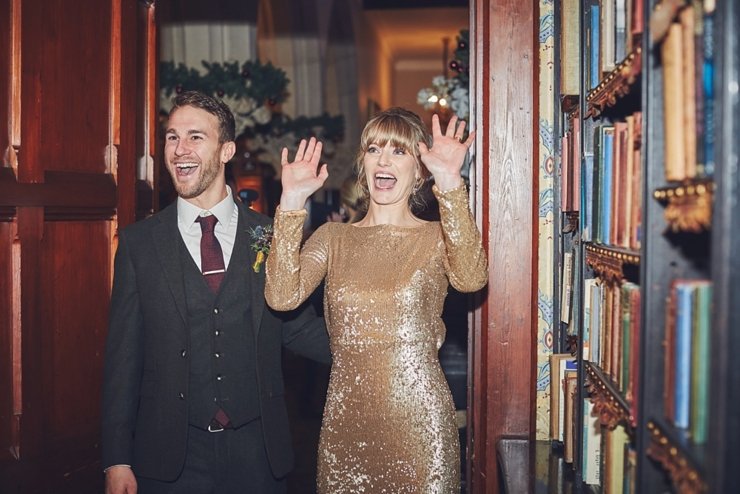 entrance of the bride and groom to wedding breakfast at winter wedding at huntsham court