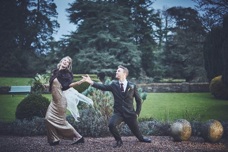 bride in gold sequinned gown and groom being silly during relaxed portrait session at Huntsham Court Devon