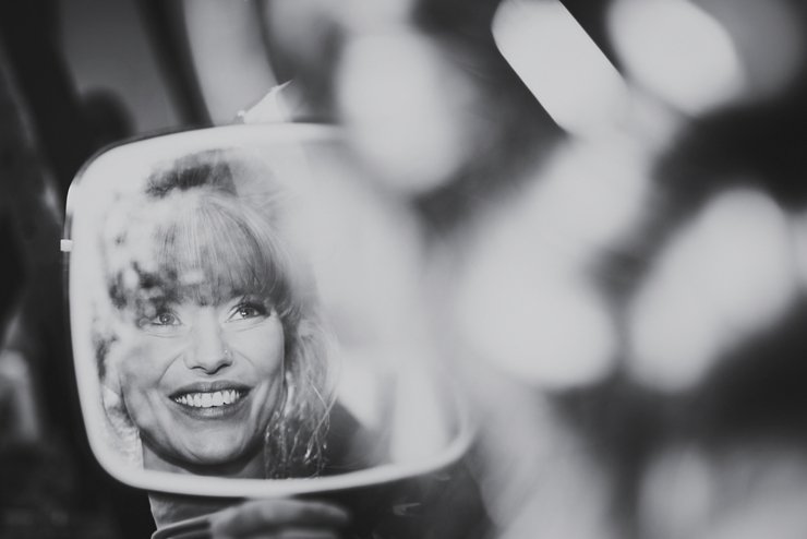 Bride's happy reflection in hand mirror at Huntsham Court Devon Wedding photography