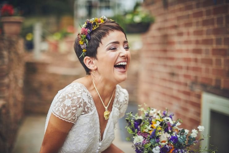 bride to be laughing wearing flower crown