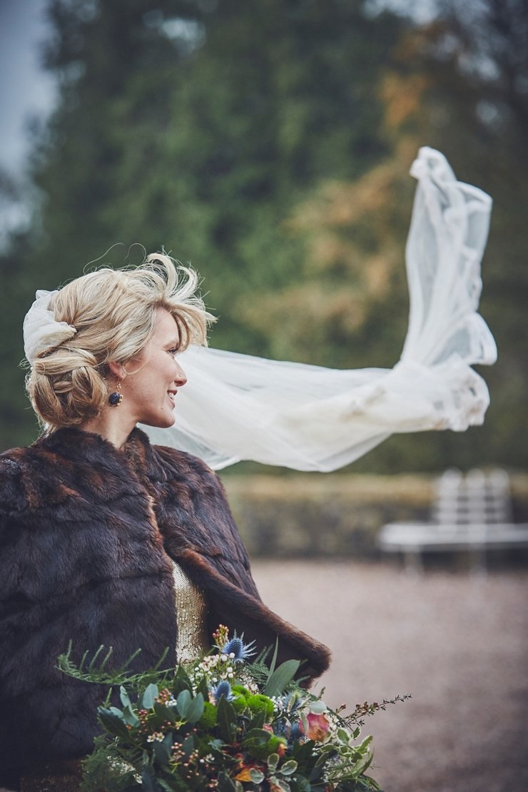 bride's veil blowing at winter wedding at Huntsham Court Devon