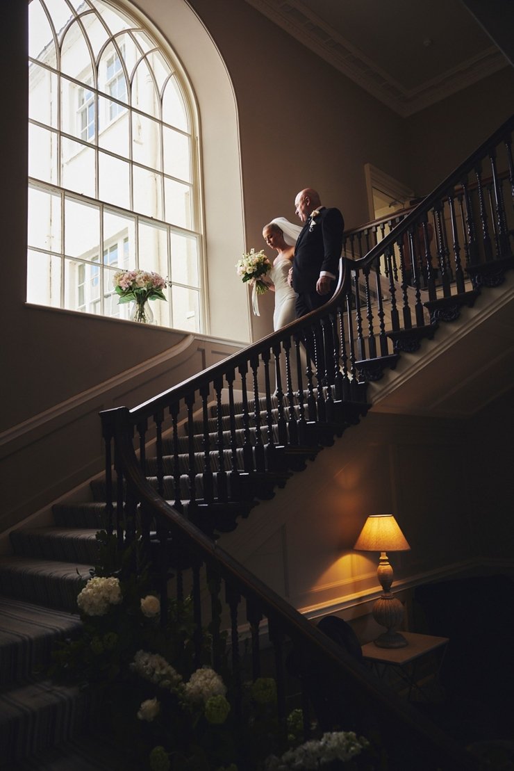 bride and father on the stairs at Rockbeare Manor