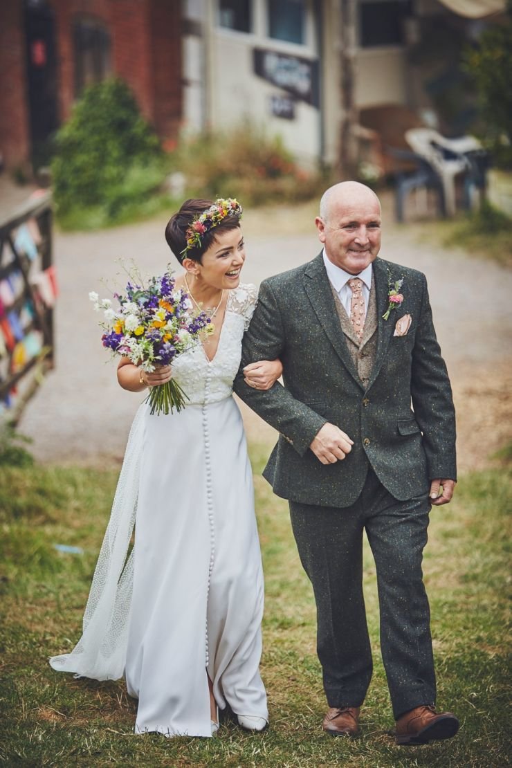 Bride and father walking to ceremony at a wedding at West Town Farm in Exeter 
