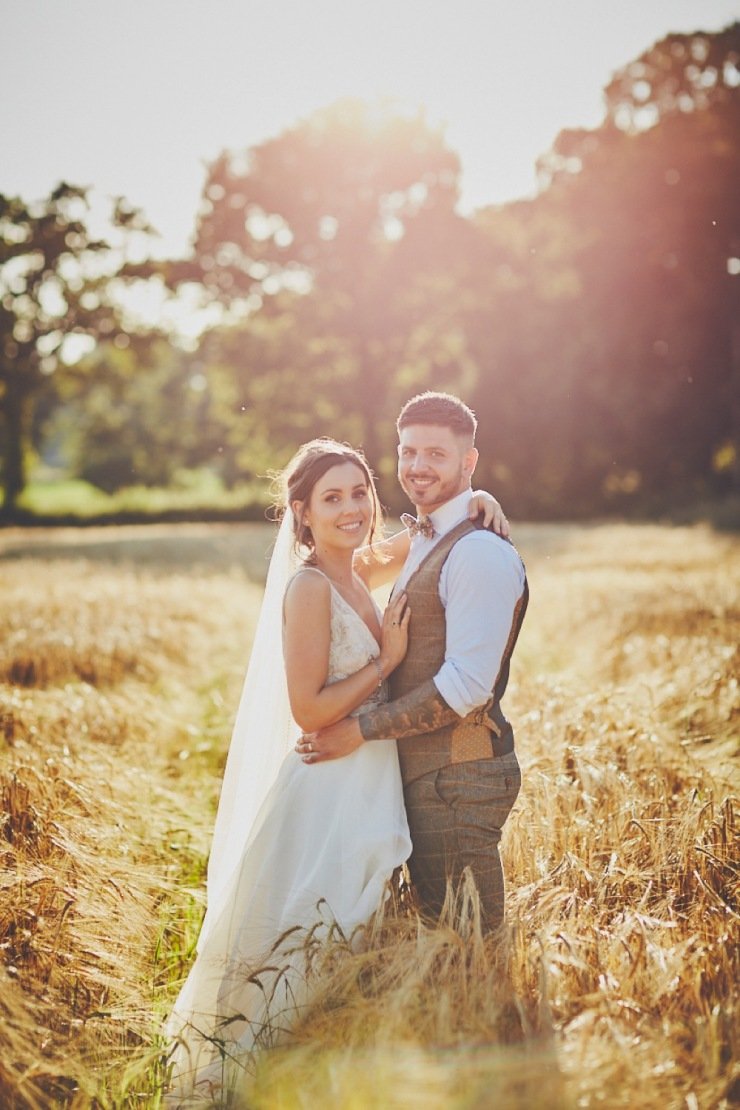 couple in the cornfield at summer wedding in Devon