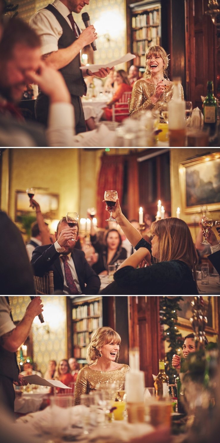 documentary photography of guests listening to and toasting the speeches at Devon winter wedding at huntsham court